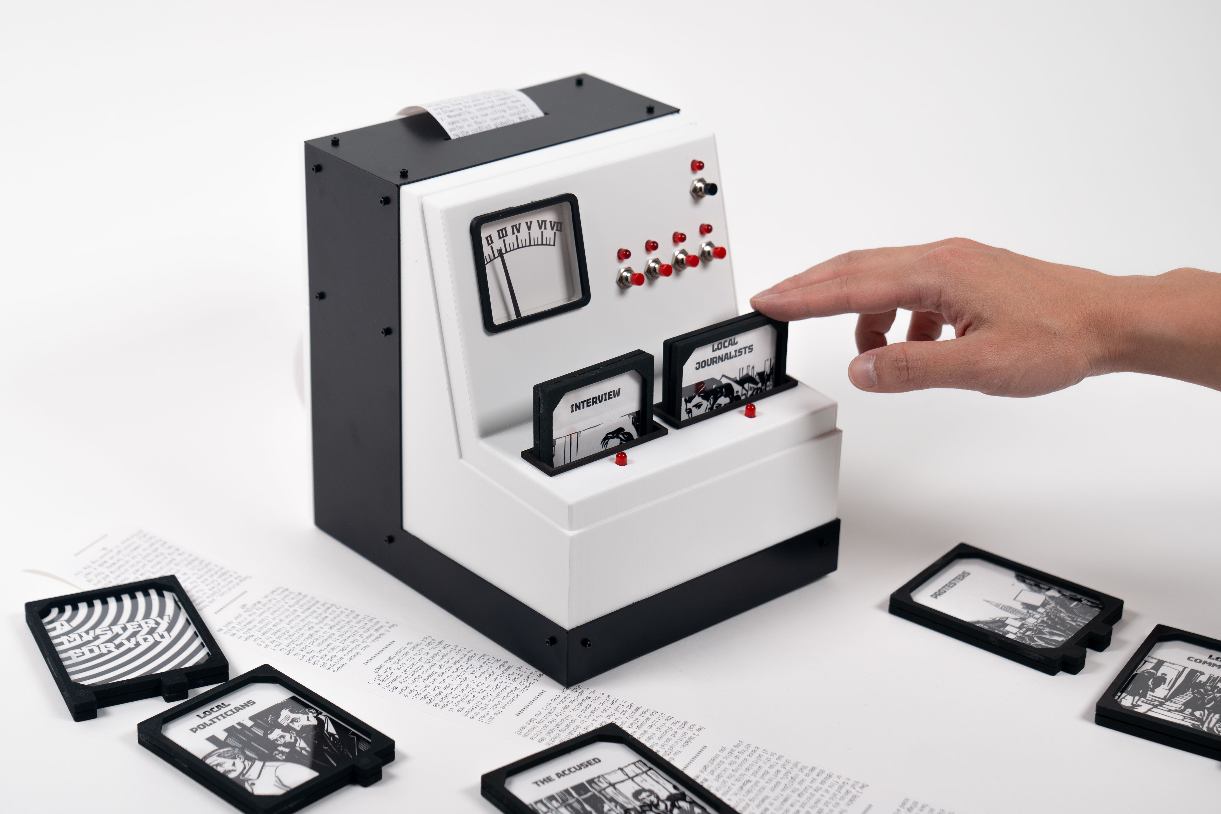 Image showing a hand inputting an 'actor' cartridge into the tangible game interface.